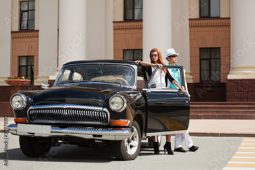 Photo: Young couple with a retro car Young couple with a retro car