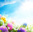 Foto: Art Easter eggs decorated with flowers in the grass on blue sky Art Easter eggs decorated with flowers in the grass on blue sky