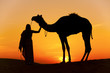 Photo: Women holding a camel the Thar Desert, Rajasthan - India Women holding a camel the Thar Desert, Rajasthan - India