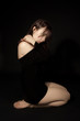 Woman with wet hair sitting on her knees
