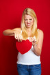 young disappointed woman with a heart