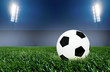 Photo: Soccer ball on grass field with spotlights Soccer ball on grass field with spotlights