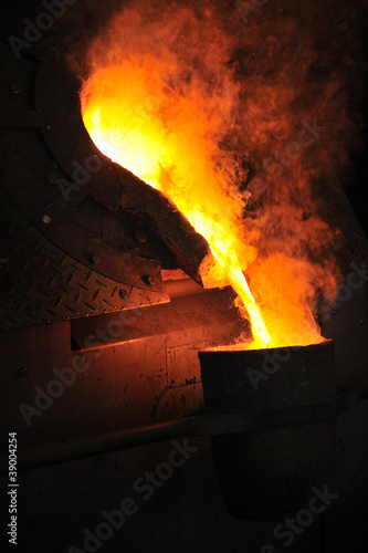 Photo: Foundry - molten metal poured from ladle for casting Foundry - molten metal poured from ladle for casting