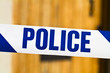 Foto: Police tape across an open door Police tape across an open door