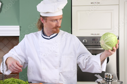 Photo: Young chef preparing lunch in kitchen Young chef preparing lunch in kitchen