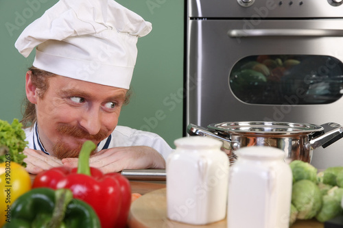 Photo: Young chef preparing lunch in kitchen Young chef preparing lunch in kitchen