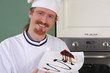 Photo: Young chef with piece of cake Young chef with piece of cake