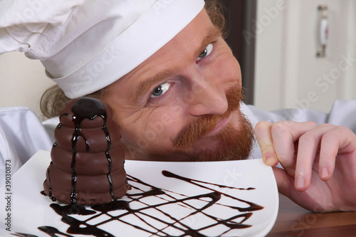 Photo: Young chef with piece of cake Young chef with piece of cake