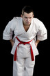 Contrast karate young fighter on black