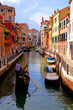 Gondolier along a picturesque canal in Venice, Italy Gondolier along a picturesque canal in Venice, Italy