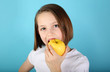 Girl eating a yellow apple