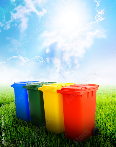 Photo: Colorful recycle bins with landscape background Colorful recycle bins with landscape background