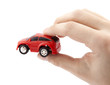 Hand holding a small red car