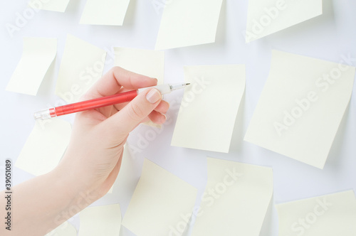 Photo: Human hand Writing on Sticky Note Human hand Writing on Sticky Note