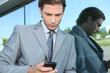 Photo: Young executive using a mobile phone Young executive using a mobile phone