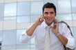 Businessman on a mobile phone outside a city building