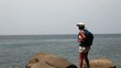 Woman travels along the sea.