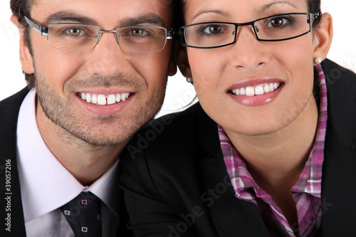 Photo: Smiling man woman wearing pairs of eyeglasses Smiling man woman wearing pairs of eyeglasses