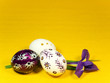 Three easter eggs and iris on yellow