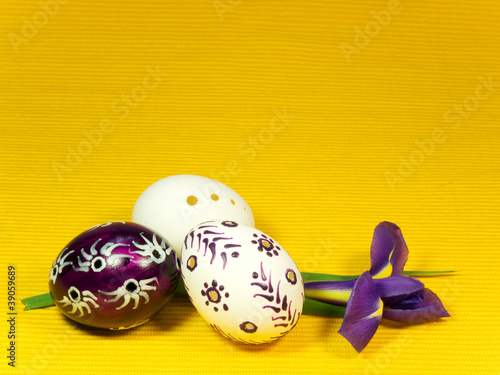 Photo: Three easter eggs and iris on yellow Three easter eggs and iris on yellow