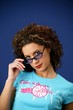 Frizzy haired woman removing sunglasses