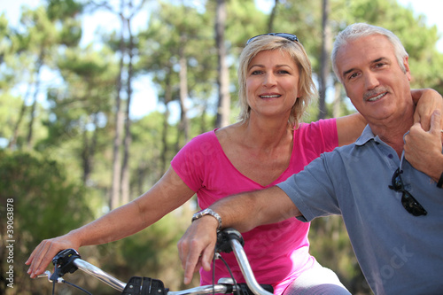 Photo: Older couple riding bikes Older couple riding bikes