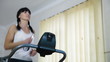 woman running on a treadmill at home