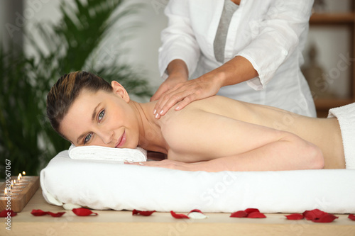 Photo: Girl having back massage in beauty parlor Girl having back massage in beauty parlor