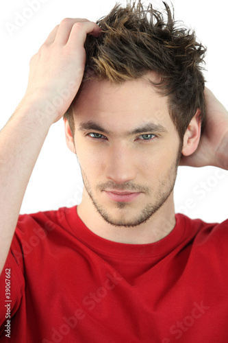 Photo: Man applying product to style hair Man applying product to style hair