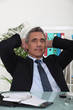 businessman with his hands behind his head