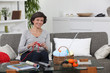 woman sitting on settee knitting