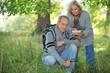 Couple inspecting plants in the forest and making a log