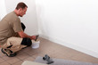 handyman laying fitted carpet