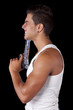 Man aiming a handgun at his head