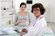 pregnant woman and in obstetrician's surgery