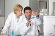Laboratory team examining blue liquid