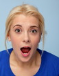 Portrait of beautiful surprised blonde girl on blue Portrait of beautiful surprised blonde girl on blue