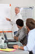 Young men in classroom with trainer