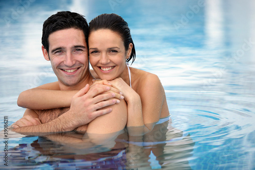 Photo: Happy couple hugging in a swimming-pool Happy couple hugging in a swimming-pool