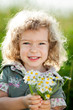 Child with bunch of spring flowers