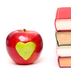 apple with green heart and stack of books
