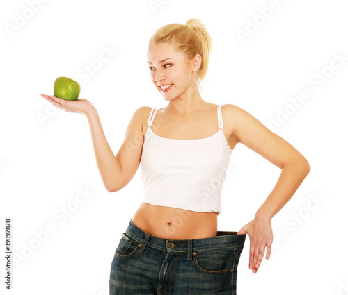 Young girl with big jeans and apple