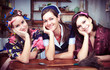 Portrait of three cheerful housewives