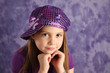Cute young girl wearing a purple hat