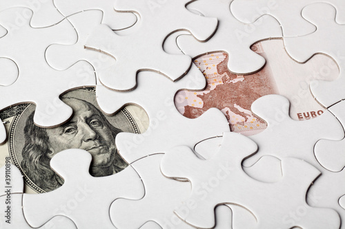 Photo: US and Euro currencies as part of a jigsaw puzzle US and Euro currencies as part of a jigsaw puzzle