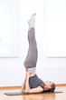 Woman doing stretching yoga exercise at sport gym