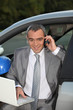 Architect in car speaking on mobile telephone