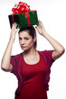Pretty young woman with present on her head