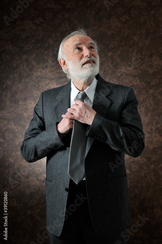 Photo: a man fixes his tie a man fixes his tie