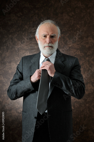 Photo: a man fixes the tie a man fixes the tie